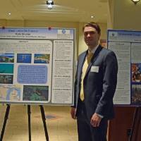 Kyle Gloster with his research poster